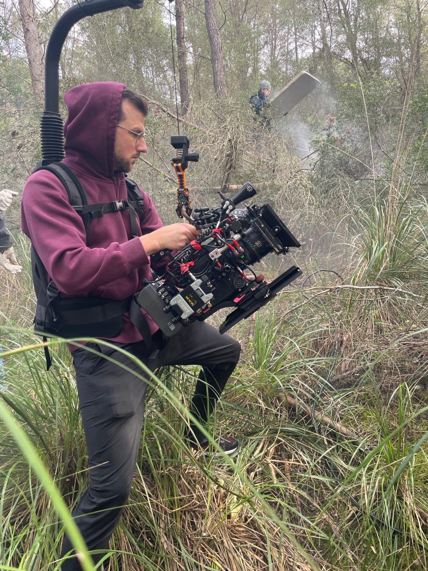cameraman holds an arri alexa mini in a forest which is supported by an easyrig
