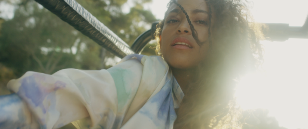 a girl rides in a car for the sloth Nicky Jam music video in mallorca